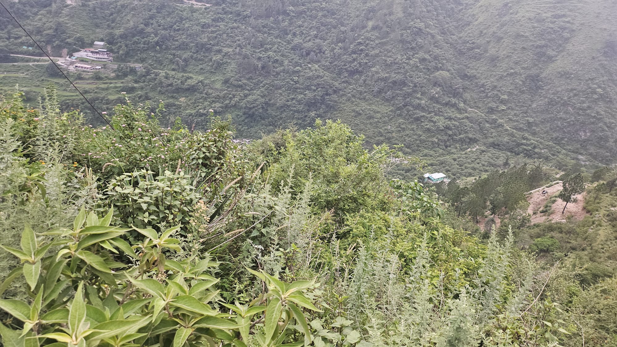 Looking down the slope from the land towards the village and fields below